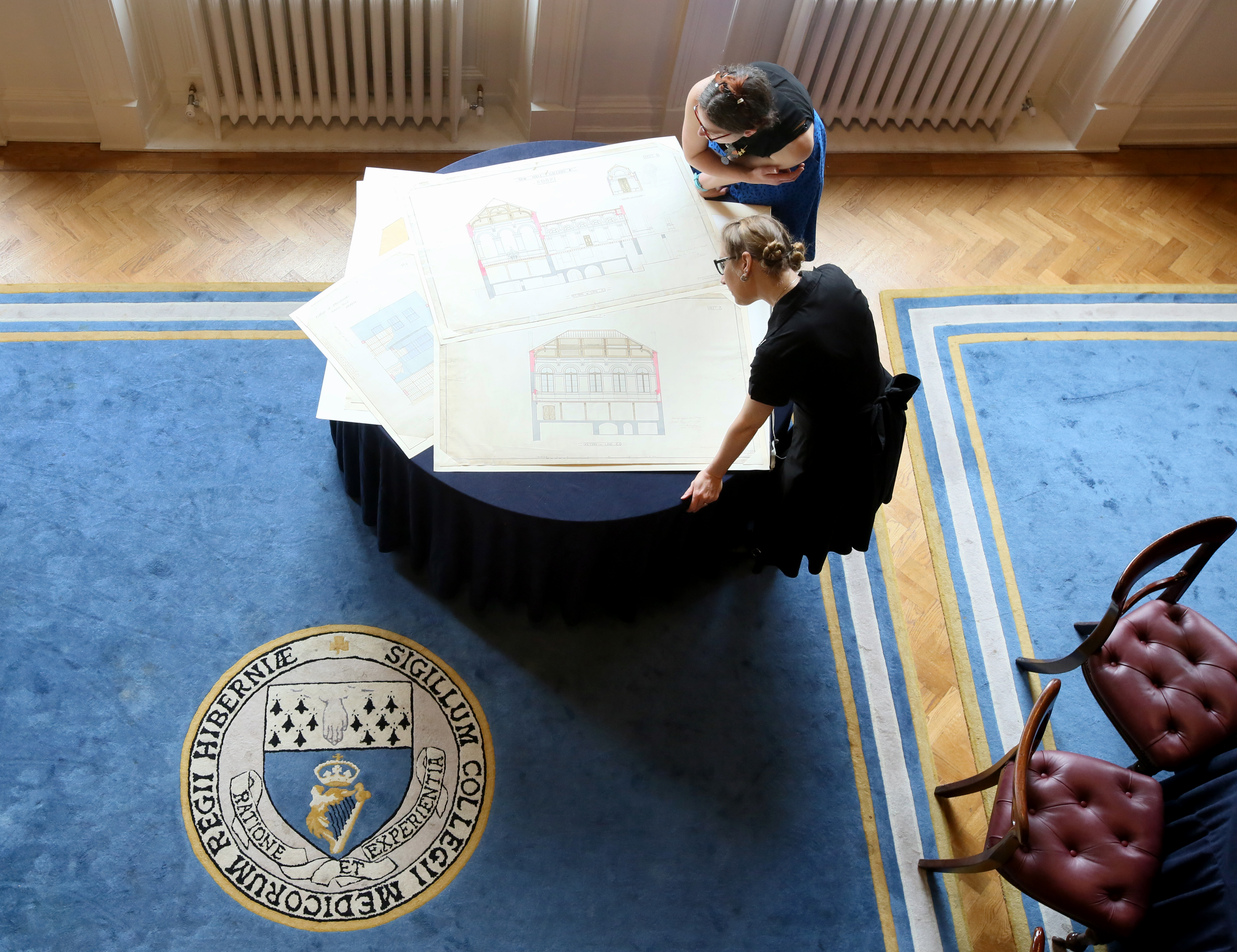 Members of the RCPI Heritage Centre team reviewing drawing plans of No 6 Kildare Street